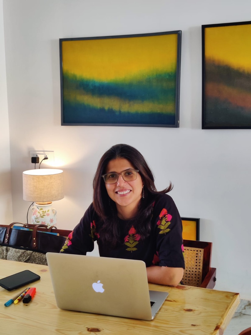 Jasneet, behaviour-change coach at Habits Over Diets, smiling at her desk